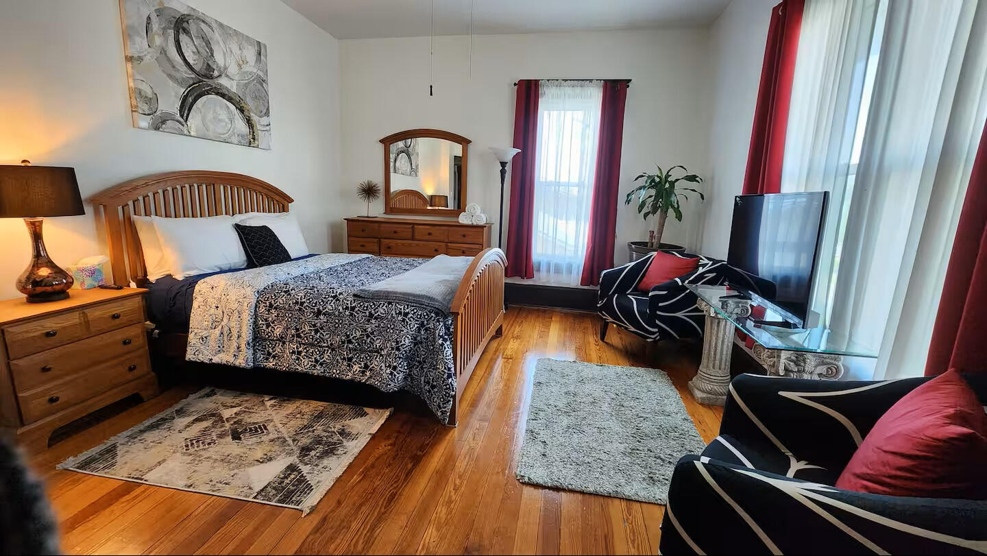 Guest Bedroom • Spacious Layout with TV & Natural Light